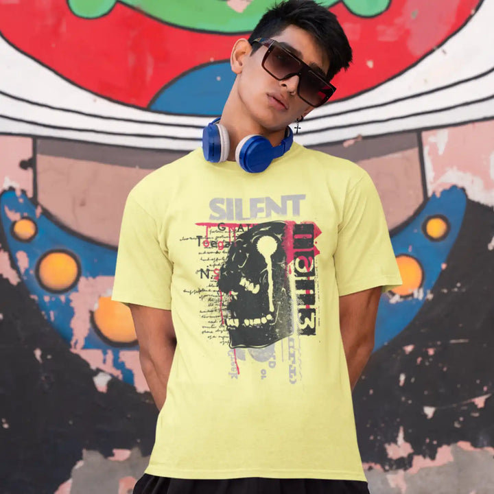 a male model wearing the butter yellow sapienwear men's tshirt with the "screaming skull" graphic on the front