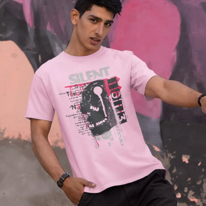 a male model wearing the light pink sapienwear men's tshirt with the "screaming skull" graphic on the front