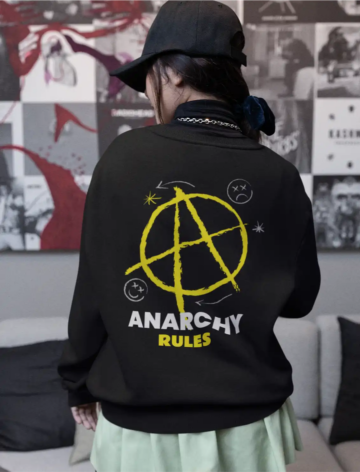 a model wearing a black sapienwear sweatshirt with the anarchy rules design on the back side.